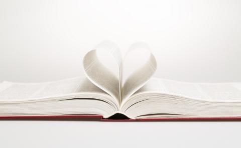 Book with pages curled into a heart shape